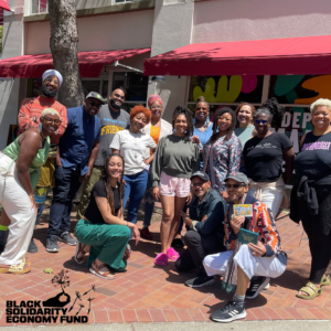 Group of Black people posed and smiling for a photo